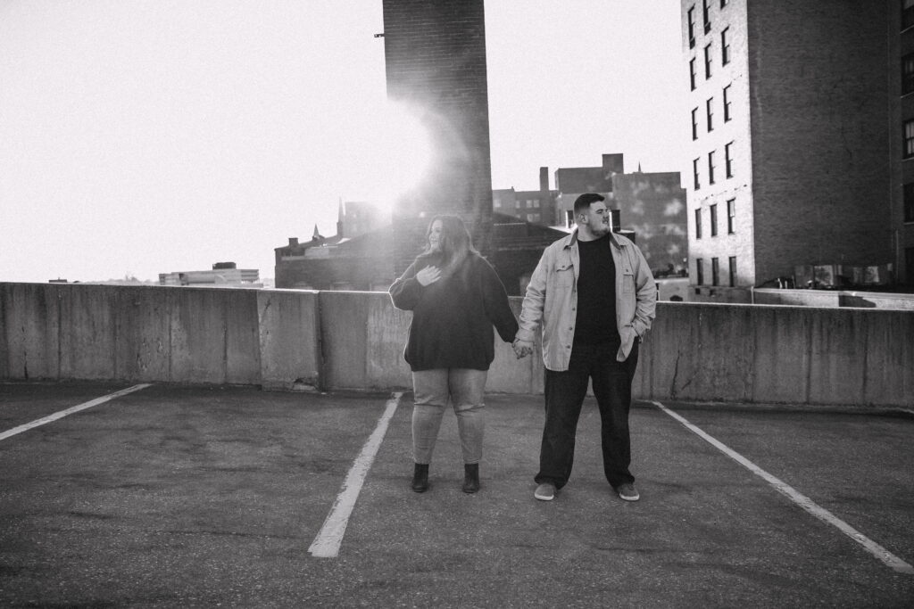 Capturing Love and Emotion: Moody and Romantic Engagement Portraits in Downtown Erie and Pittsburgh, PA by Rylee Louisa Photography. Specializing in Candid Moments on Rooftop Parking Garages, this Wedding and Couples Photographer beautifully portrays the Emotional Essence of Love in Urban Landscapes.