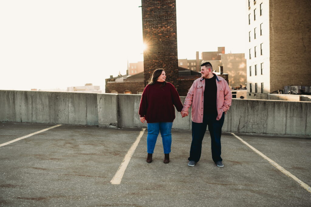 Capturing Love and Emotion: Moody and Romantic Engagement Portraits in Downtown Erie and Pittsburgh, PA by Rylee Louisa Photography. Specializing in Candid Moments on Rooftop Parking Garages, this Wedding and Couples Photographer beautifully portrays the Emotional Essence of Love in Urban Landscapes.