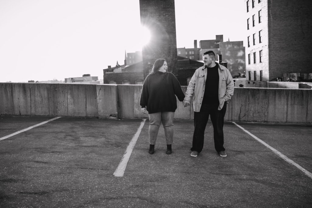 Capturing Love and Emotion: Moody and Romantic Engagement Portraits in Downtown Erie and Pittsburgh, PA by Rylee Louisa Photography. Specializing in Candid Moments on Rooftop Parking Garages, this Wedding and Couples Photographer beautifully portrays the Emotional Essence of Love in Urban Landscapes.