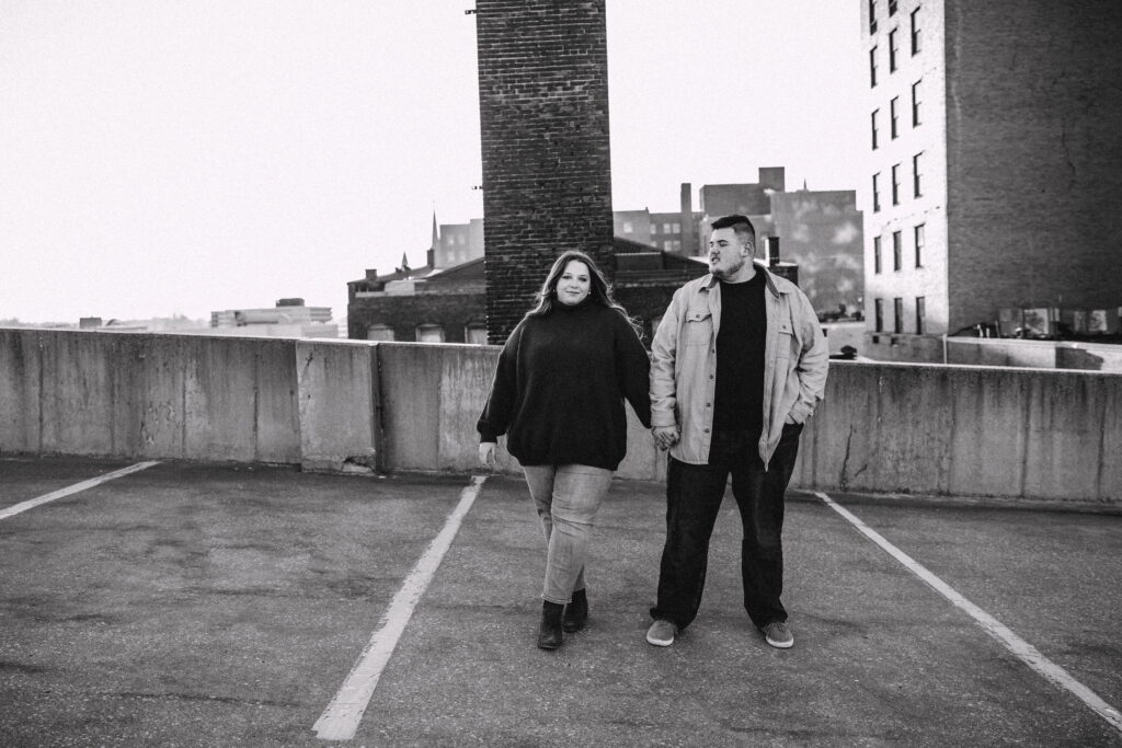 Capturing Love and Emotion: Moody and Romantic Engagement Portraits in Downtown Erie and Pittsburgh, PA by Rylee Louisa Photography. Specializing in Candid Moments on Rooftop Parking Garages, this Wedding and Couples Photographer beautifully portrays the Emotional Essence of Love in Urban Landscapes.
