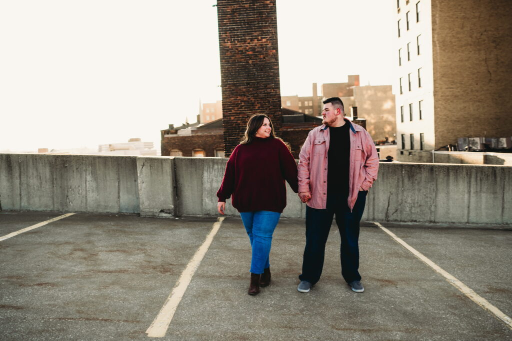 Capturing Love and Emotion: Moody and Romantic Engagement Portraits in Downtown Erie and Pittsburgh, PA by Rylee Louisa Photography. Specializing in Candid Moments on Rooftop Parking Garages, this Wedding and Couples Photographer beautifully portrays the Emotional Essence of Love in Urban Landscapes.