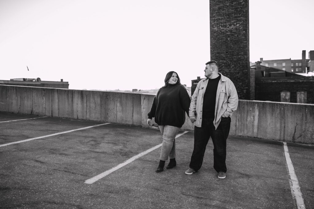 Capturing Love and Emotion: Moody and Romantic Engagement Portraits in Downtown Erie and Pittsburgh, PA by Rylee Louisa Photography. Specializing in Candid Moments on Rooftop Parking Garages, this Wedding and Couples Photographer beautifully portrays the Emotional Essence of Love in Urban Landscapes.