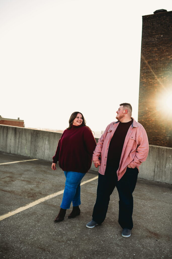 Capturing Love and Emotion: Moody and Romantic Engagement Portraits in Downtown Erie and Pittsburgh, PA by Rylee Louisa Photography. Specializing in Candid Moments on Rooftop Parking Garages, this Wedding and Couples Photographer beautifully portrays the Emotional Essence of Love in Urban Landscapes.