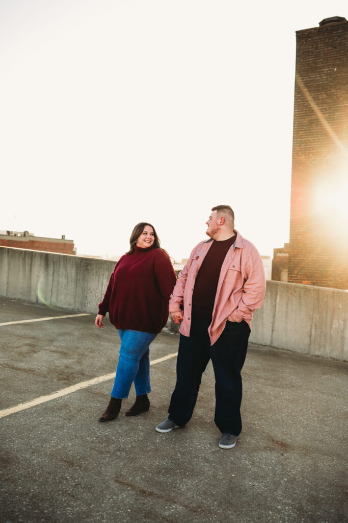 Capturing Love and Emotion: Moody and Romantic Engagement Portraits in Downtown Erie and Pittsburgh, PA by Rylee Louisa Photography. Specializing in Candid Moments on Rooftop Parking Garages, this Wedding and Couples Photographer beautifully portrays the Emotional Essence of Love in Urban Landscapes.