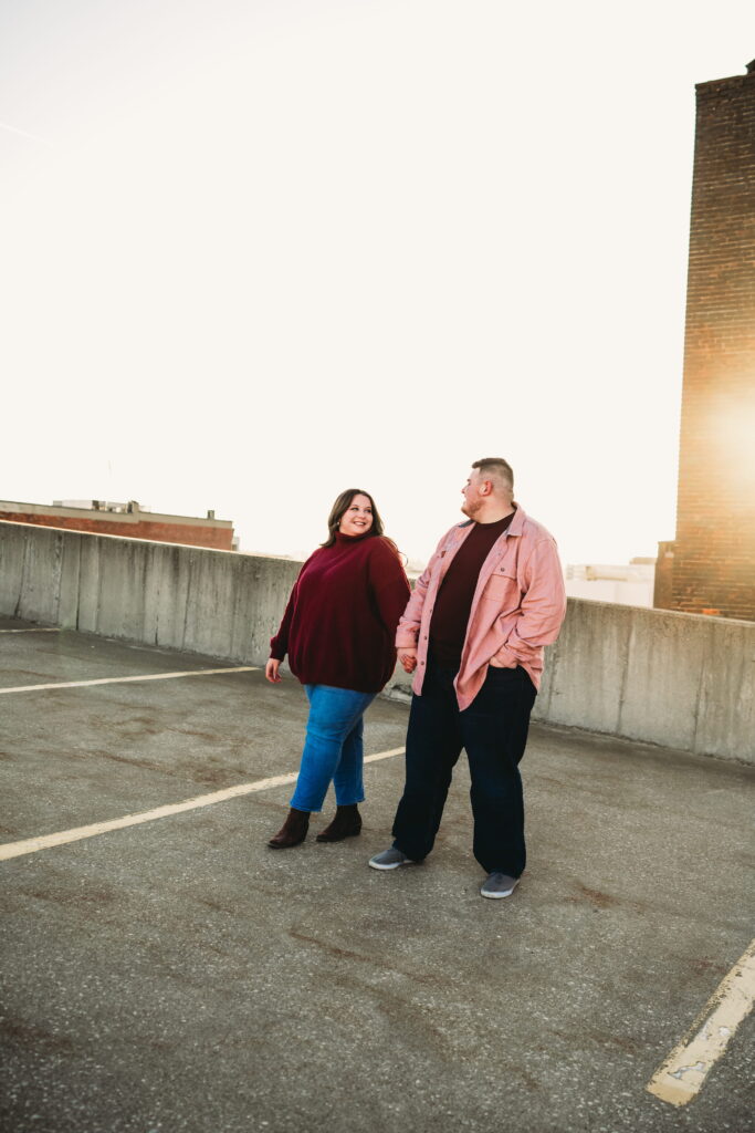 Capturing Love and Emotion: Moody and Romantic Engagement Portraits in Downtown Erie and Pittsburgh, PA by Rylee Louisa Photography. Specializing in Candid Moments on Rooftop Parking Garages, this Wedding and Couples Photographer beautifully portrays the Emotional Essence of Love in Urban Landscapes.