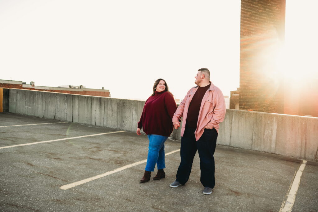 Capturing Love and Emotion: Moody and Romantic Engagement Portraits in Downtown Erie and Pittsburgh, PA by Rylee Louisa Photography. Specializing in Candid Moments on Rooftop Parking Garages, this Wedding and Couples Photographer beautifully portrays the Emotional Essence of Love in Urban Landscapes.