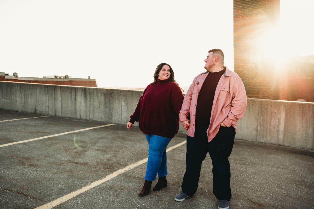 Capturing Love and Emotion: Moody and Romantic Engagement Portraits in Downtown Erie and Pittsburgh, PA by Rylee Louisa Photography. Specializing in Candid Moments on Rooftop Parking Garages, this Wedding and Couples Photographer beautifully portrays the Emotional Essence of Love in Urban Landscapes.