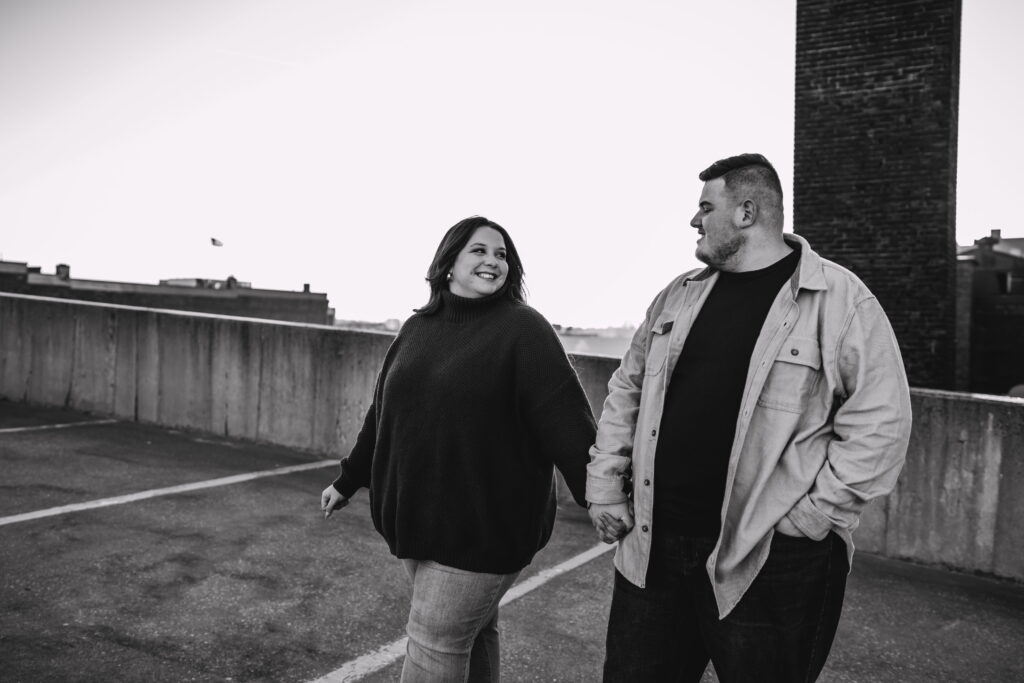 Capturing Love and Emotion: Moody and Romantic Engagement Portraits in Downtown Erie and Pittsburgh, PA by Rylee Louisa Photography. Specializing in Candid Moments on Rooftop Parking Garages, this Wedding and Couples Photographer beautifully portrays the Emotional Essence of Love in Urban Landscapes.