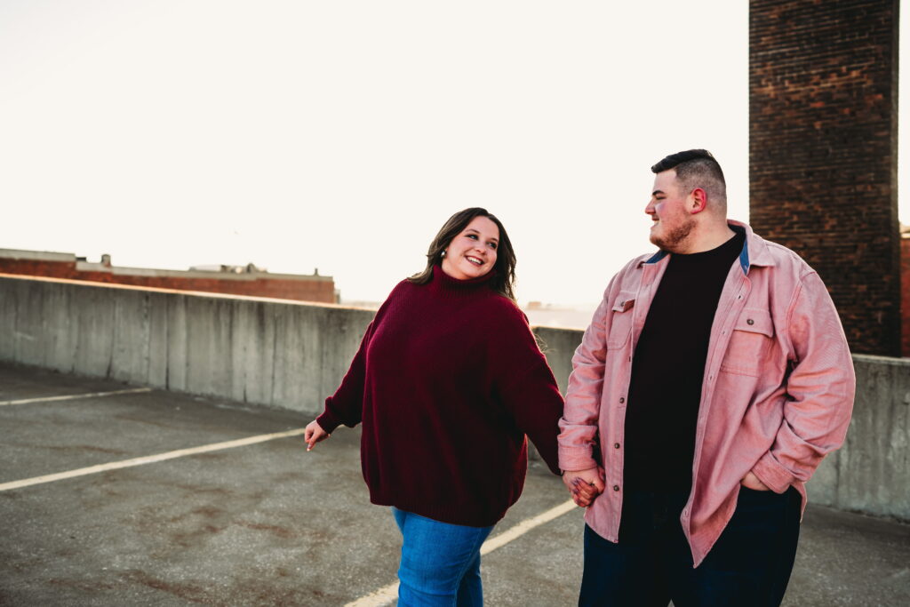 Capturing Love and Emotion: Moody and Romantic Engagement Portraits in Downtown Erie and Pittsburgh, PA by Rylee Louisa Photography. Specializing in Candid Moments on Rooftop Parking Garages, this Wedding and Couples Photographer beautifully portrays the Emotional Essence of Love in Urban Landscapes.