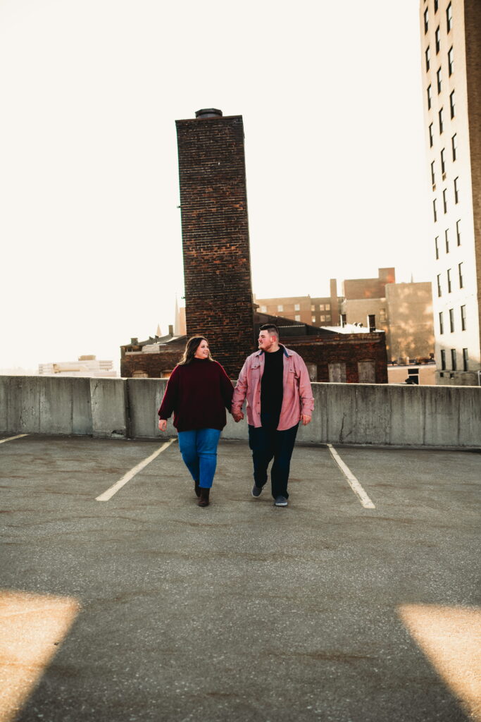 Capturing Love and Emotion: Moody and Romantic Engagement Portraits in Downtown Erie and Pittsburgh, PA by Rylee Louisa Photography. Specializing in Candid Moments on Rooftop Parking Garages, this Wedding and Couples Photographer beautifully portrays the Emotional Essence of Love in Urban Landscapes.