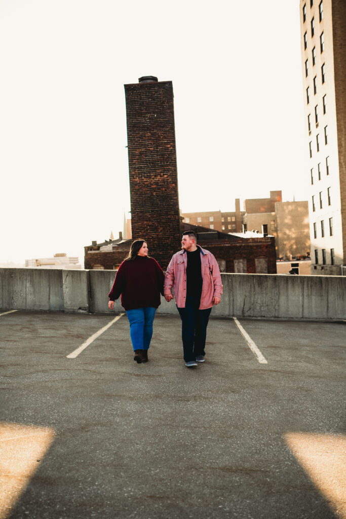 Capturing Love and Emotion: Moody and Romantic Engagement Portraits in Downtown Erie and Pittsburgh, PA by Rylee Louisa Photography. Specializing in Candid Moments on Rooftop Parking Garages, this Wedding and Couples Photographer beautifully portrays the Emotional Essence of Love in Urban Landscapes.