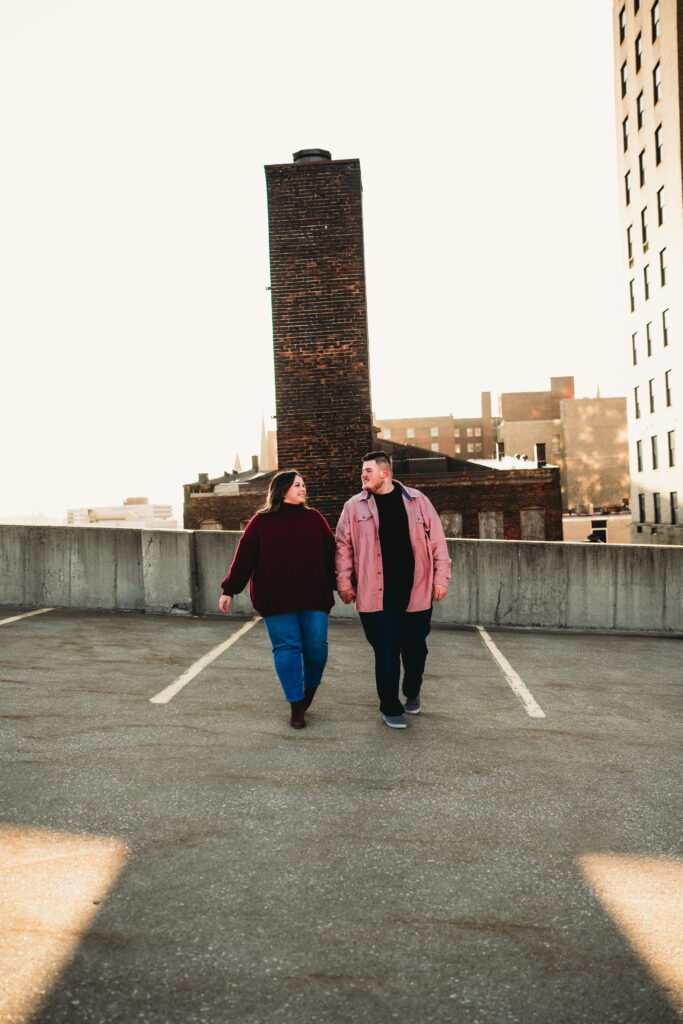 Capturing Love and Emotion: Moody and Romantic Engagement Portraits in Downtown Erie and Pittsburgh, PA by Rylee Louisa Photography. Specializing in Candid Moments on Rooftop Parking Garages, this Wedding and Couples Photographer beautifully portrays the Emotional Essence of Love in Urban Landscapes.