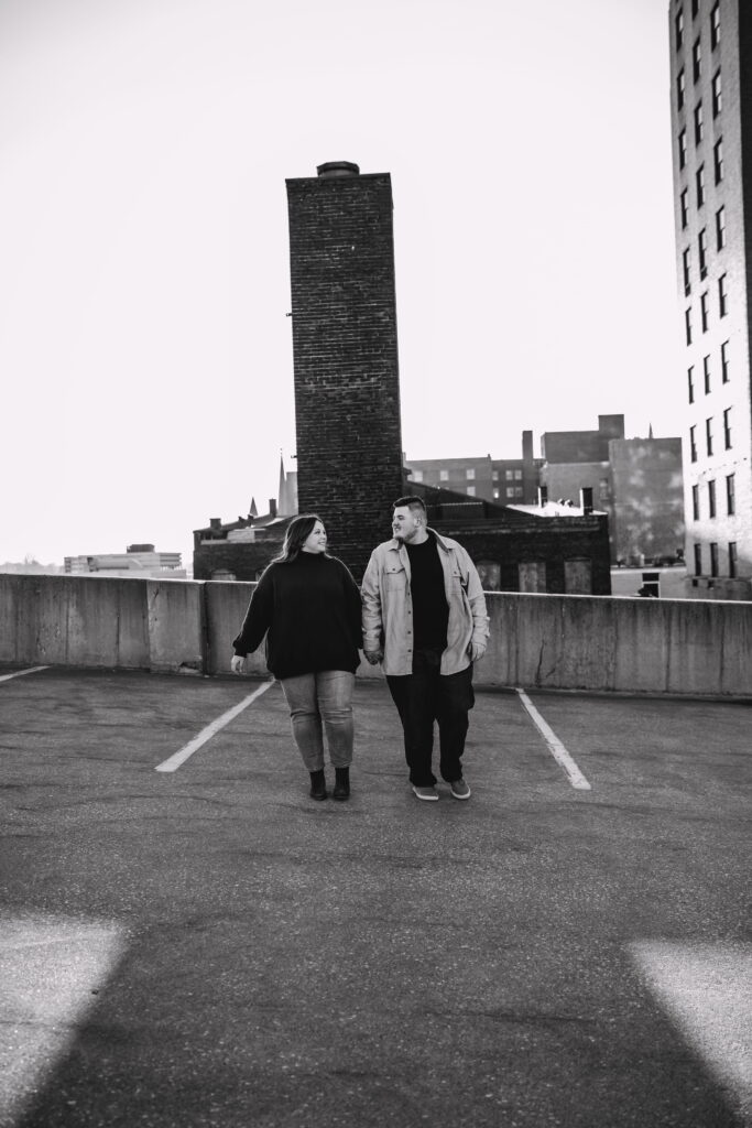 Capturing Love and Emotion: Moody and Romantic Engagement Portraits in Downtown Erie and Pittsburgh, PA by Rylee Louisa Photography. Specializing in Candid Moments on Rooftop Parking Garages, this Wedding and Couples Photographer beautifully portrays the Emotional Essence of Love in Urban Landscapes.