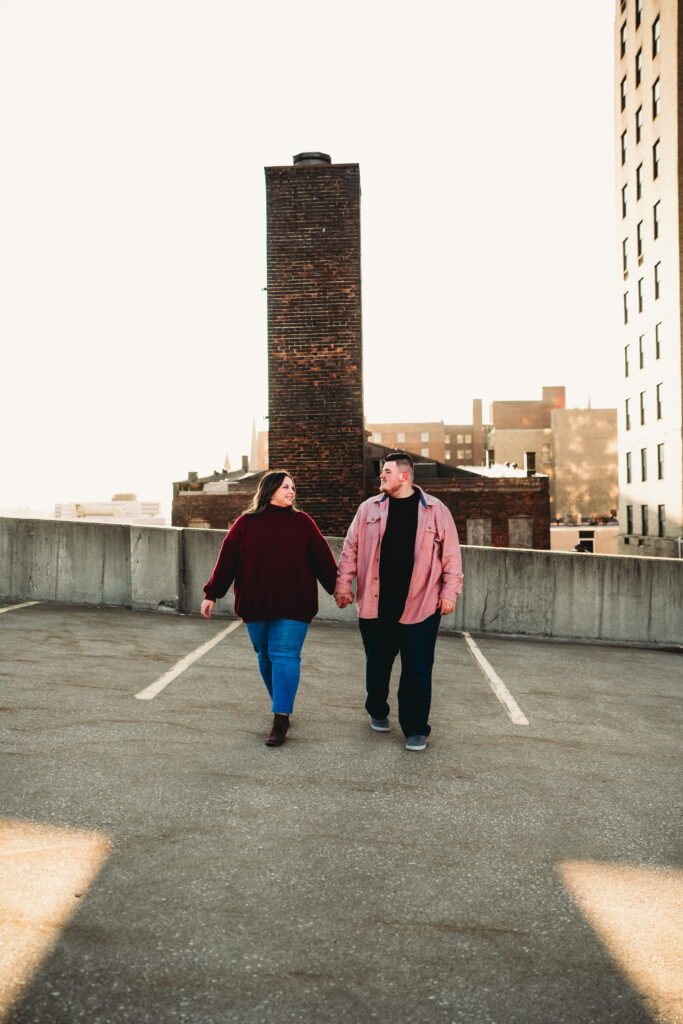 Capturing Love and Emotion: Moody and Romantic Engagement Portraits in Downtown Erie and Pittsburgh, PA by Rylee Louisa Photography. Specializing in Candid Moments on Rooftop Parking Garages, this Wedding and Couples Photographer beautifully portrays the Emotional Essence of Love in Urban Landscapes.