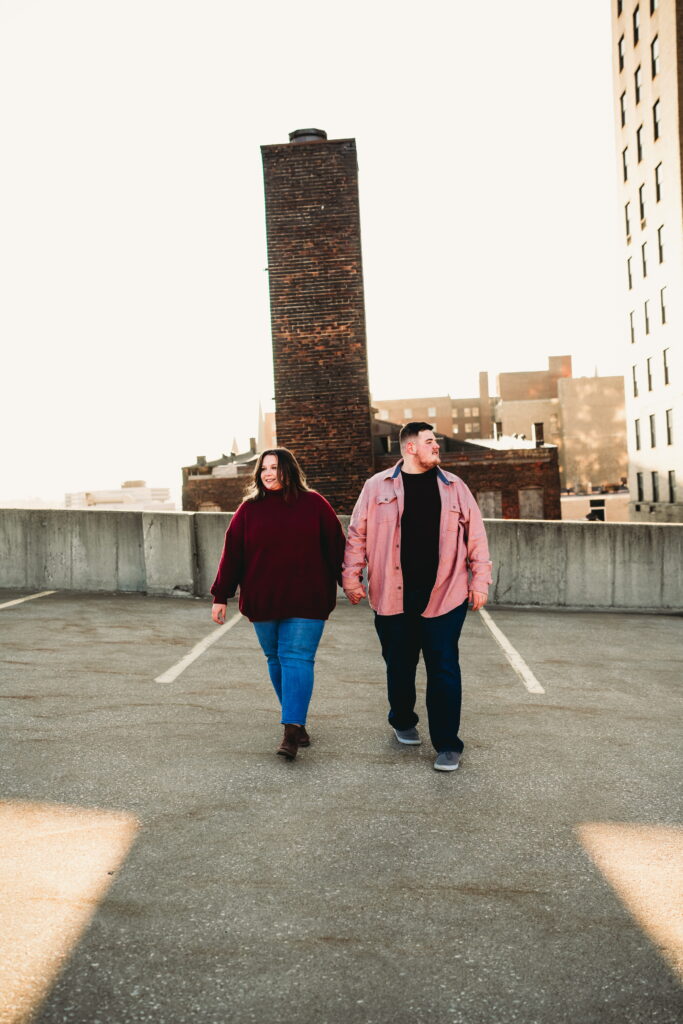 Capturing Love and Emotion: Moody and Romantic Engagement Portraits in Downtown Erie and Pittsburgh, PA by Rylee Louisa Photography. Specializing in Candid Moments on Rooftop Parking Garages, this Wedding and Couples Photographer beautifully portrays the Emotional Essence of Love in Urban Landscapes.
