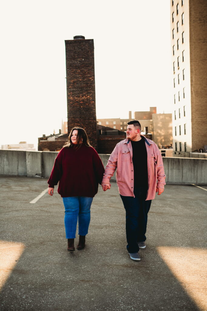 Capturing Love and Emotion: Moody and Romantic Engagement Portraits in Downtown Erie and Pittsburgh, PA by Rylee Louisa Photography. Specializing in Candid Moments on Rooftop Parking Garages, this Wedding and Couples Photographer beautifully portrays the Emotional Essence of Love in Urban Landscapes.