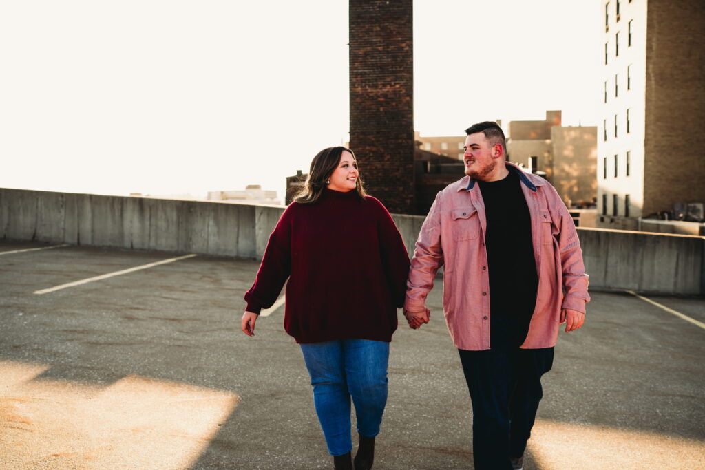 Capturing Love and Emotion: Moody and Romantic Engagement Portraits in Downtown Erie and Pittsburgh, PA by Rylee Louisa Photography. Specializing in Candid Moments on Rooftop Parking Garages, this Wedding and Couples Photographer beautifully portrays the Emotional Essence of Love in Urban Landscapes.