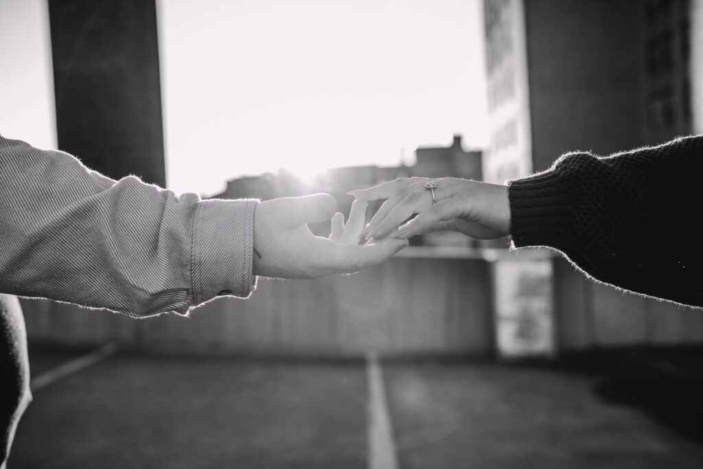 Capturing Love and Emotion: Moody and Romantic Engagement Portraits in Downtown Erie and Pittsburgh, PA by Rylee Louisa Photography. Specializing in Candid Moments on Rooftop Parking Garages, this Wedding and Couples Photographer beautifully portrays the Emotional Essence of Love in Urban Landscapes.