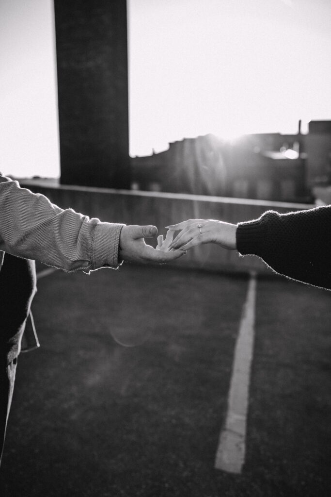 Capturing Love and Emotion: Moody and Romantic Engagement Portraits in Downtown Erie and Pittsburgh, PA by Rylee Louisa Photography. Specializing in Candid Moments on Rooftop Parking Garages, this Wedding and Couples Photographer beautifully portrays the Emotional Essence of Love in Urban Landscapes.