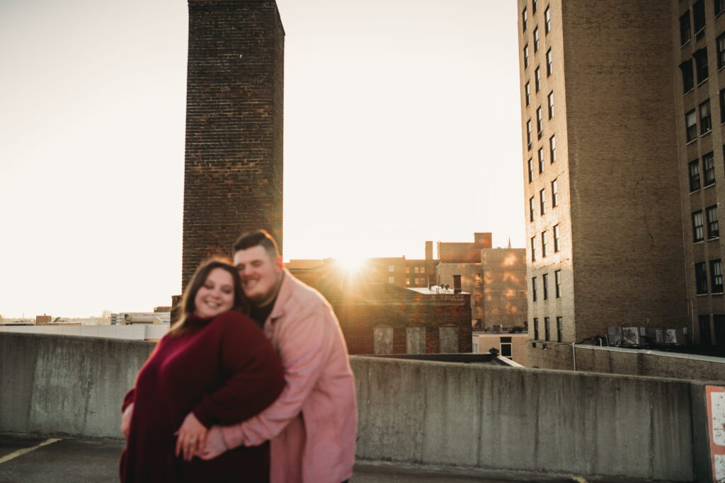 Capturing Love and Emotion: Moody and Romantic Engagement Portraits in Downtown Erie and Pittsburgh, PA by Rylee Louisa Photography. Specializing in Candid Moments on Rooftop Parking Garages, this Wedding and Couples Photographer beautifully portrays the Emotional Essence of Love in Urban Landscapes.
