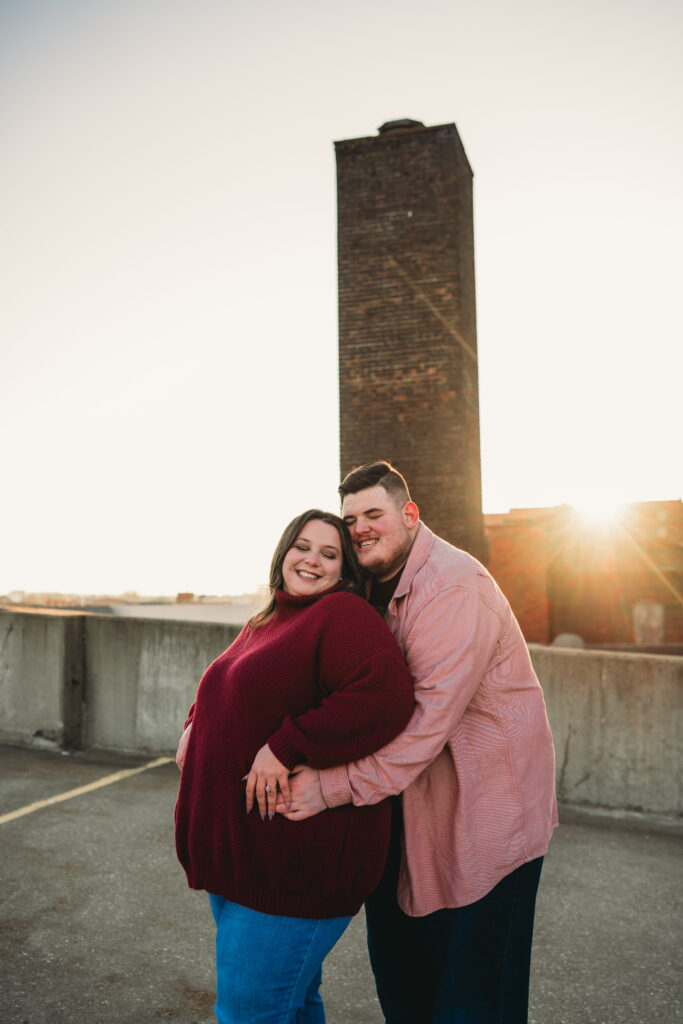 Capturing Love and Emotion: Moody and Romantic Engagement Portraits in Downtown Erie and Pittsburgh, PA by Rylee Louisa Photography. Specializing in Candid Moments on Rooftop Parking Garages, this Wedding and Couples Photographer beautifully portrays the Emotional Essence of Love in Urban Landscapes.