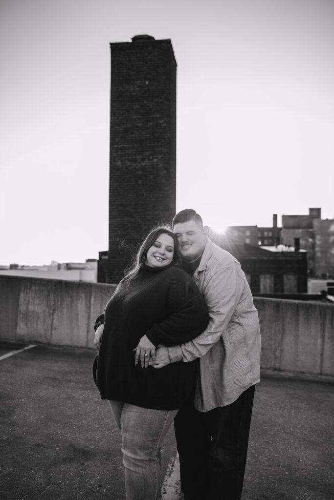 Capturing Love and Emotion: Moody and Romantic Engagement Portraits in Downtown Erie and Pittsburgh, PA by Rylee Louisa Photography. Specializing in Candid Moments on Rooftop Parking Garages, this Wedding and Couples Photographer beautifully portrays the Emotional Essence of Love in Urban Landscapes.