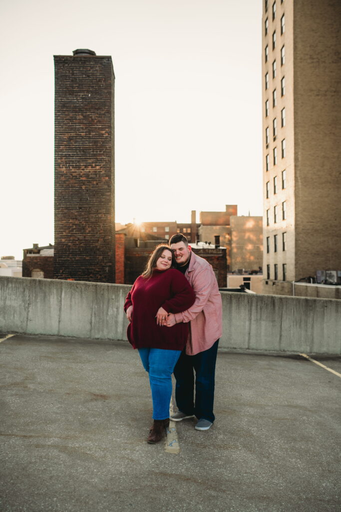Capturing Love and Emotion: Moody and Romantic Engagement Portraits in Downtown Erie and Pittsburgh, PA by Rylee Louisa Photography. Specializing in Candid Moments on Rooftop Parking Garages, this Wedding and Couples Photographer beautifully portrays the Emotional Essence of Love in Urban Landscapes.
