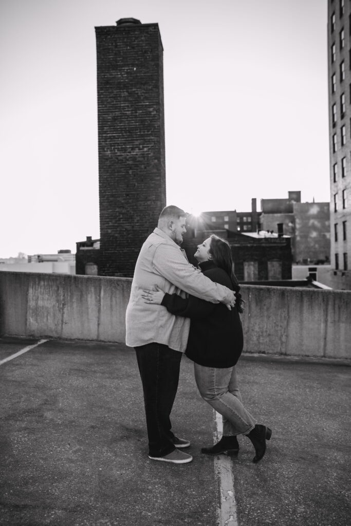 Capturing Love and Emotion: Moody and Romantic Engagement Portraits in Downtown Erie and Pittsburgh, PA by Rylee Louisa Photography. Specializing in Candid Moments on Rooftop Parking Garages, this Wedding and Couples Photographer beautifully portrays the Emotional Essence of Love in Urban Landscapes.