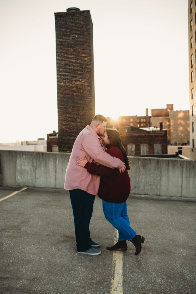 Capturing Love and Emotion: Moody and Romantic Engagement Portraits in Downtown Erie and Pittsburgh, PA by Rylee Louisa Photography. Specializing in Candid Moments on Rooftop Parking Garages, this Wedding and Couples Photographer beautifully portrays the Emotional Essence of Love in Urban Landscapes.