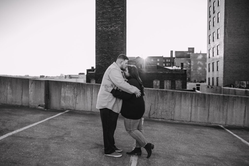 Capturing Love and Emotion: Moody and Romantic Engagement Portraits in Downtown Erie and Pittsburgh, PA by Rylee Louisa Photography. Specializing in Candid Moments on Rooftop Parking Garages, this Wedding and Couples Photographer beautifully portrays the Emotional Essence of Love in Urban Landscapes.