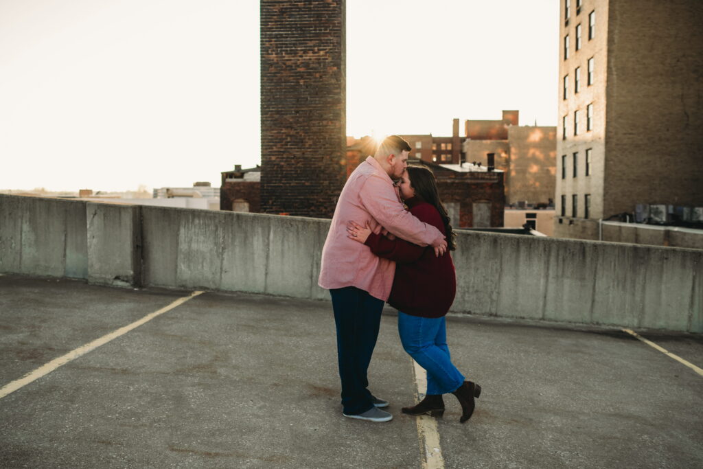 Capturing Love and Emotion: Moody and Romantic Engagement Portraits in Downtown Erie and Pittsburgh, PA by Rylee Louisa Photography. Specializing in Candid Moments on Rooftop Parking Garages, this Wedding and Couples Photographer beautifully portrays the Emotional Essence of Love in Urban Landscapes.
