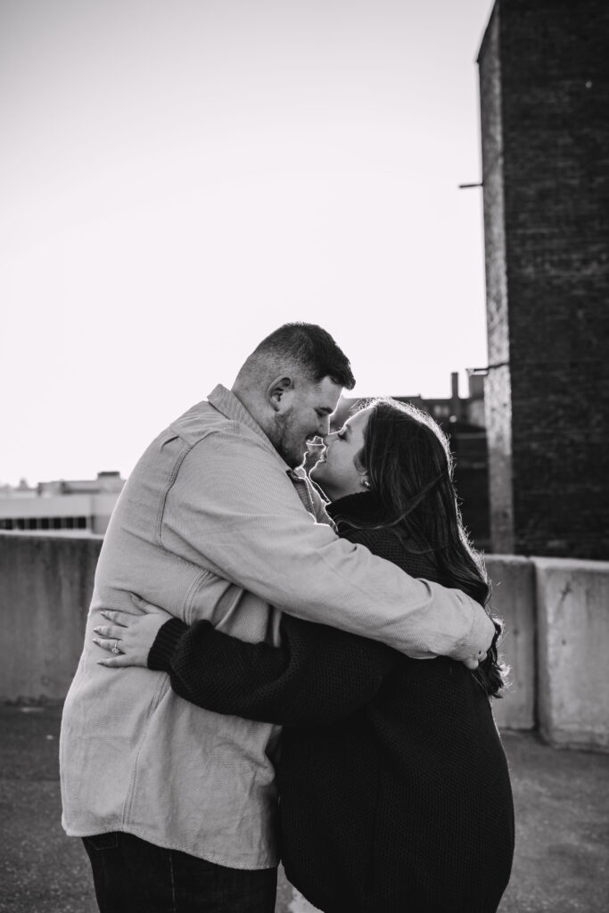 Capturing Love and Emotion: Moody and Romantic Engagement Portraits in Downtown Erie and Pittsburgh, PA by Rylee Louisa Photography. Specializing in Candid Moments on Rooftop Parking Garages, this Wedding and Couples Photographer beautifully portrays the Emotional Essence of Love in Urban Landscapes.