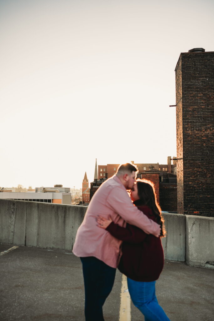 Capturing Love and Emotion: Moody and Romantic Engagement Portraits in Downtown Erie and Pittsburgh, PA by Rylee Louisa Photography. Specializing in Candid Moments on Rooftop Parking Garages, this Wedding and Couples Photographer beautifully portrays the Emotional Essence of Love in Urban Landscapes.
