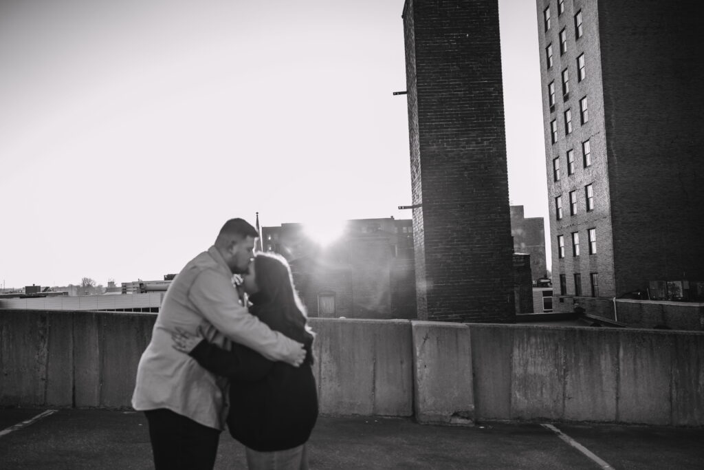 Capturing Love and Emotion: Moody and Romantic Engagement Portraits in Downtown Erie and Pittsburgh, PA by Rylee Louisa Photography. Specializing in Candid Moments on Rooftop Parking Garages, this Wedding and Couples Photographer beautifully portrays the Emotional Essence of Love in Urban Landscapes.