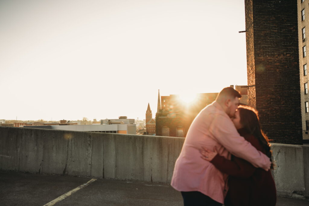 Capturing Love and Emotion: Moody and Romantic Engagement Portraits in Downtown Erie and Pittsburgh, PA by Rylee Louisa Photography. Specializing in Candid Moments on Rooftop Parking Garages, this Wedding and Couples Photographer beautifully portrays the Emotional Essence of Love in Urban Landscapes.