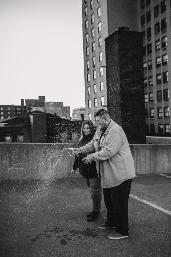 Capturing Love and Emotion: Moody and Romantic Engagement Portraits in Downtown Erie and Pittsburgh, PA by Rylee Louisa Photography. Specializing in Candid Moments on Rooftop Parking Garages, this Wedding and Couples Photographer beautifully portrays the Emotional Essence of Love in Urban Landscapes.
