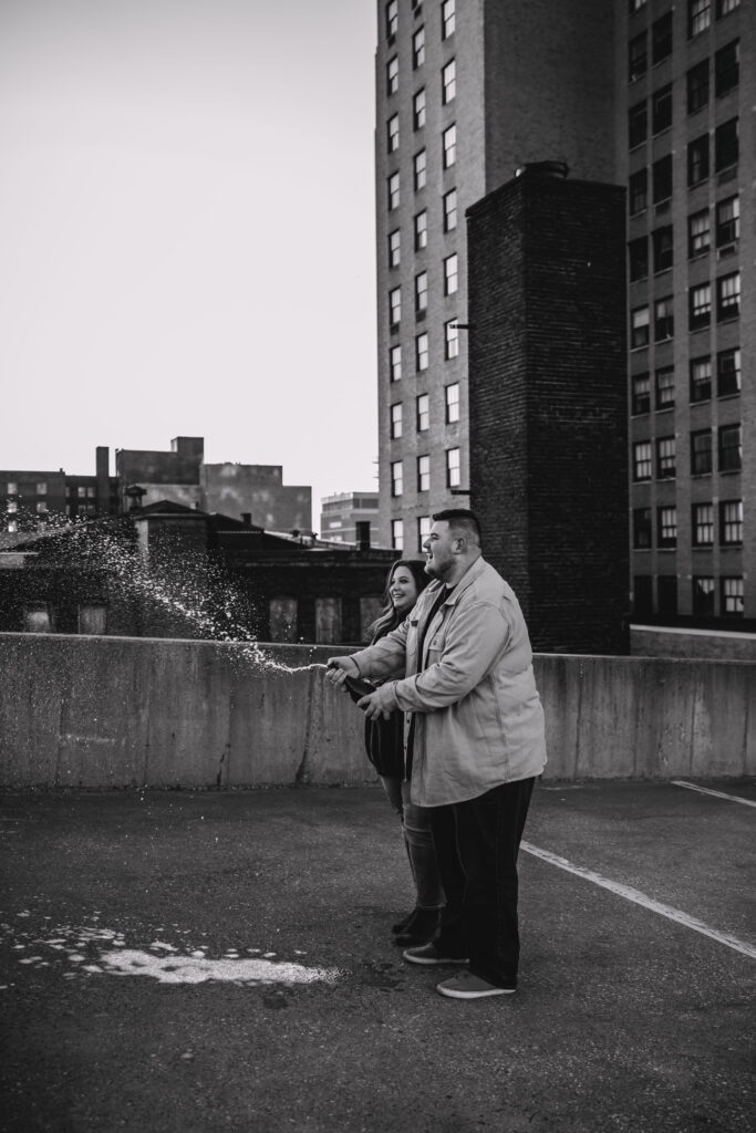 Capturing Love and Emotion: Moody and Romantic Engagement Portraits in Downtown Erie and Pittsburgh, PA by Rylee Louisa Photography. Specializing in Candid Moments on Rooftop Parking Garages, this Wedding and Couples Photographer beautifully portrays the Emotional Essence of Love in Urban Landscapes.
