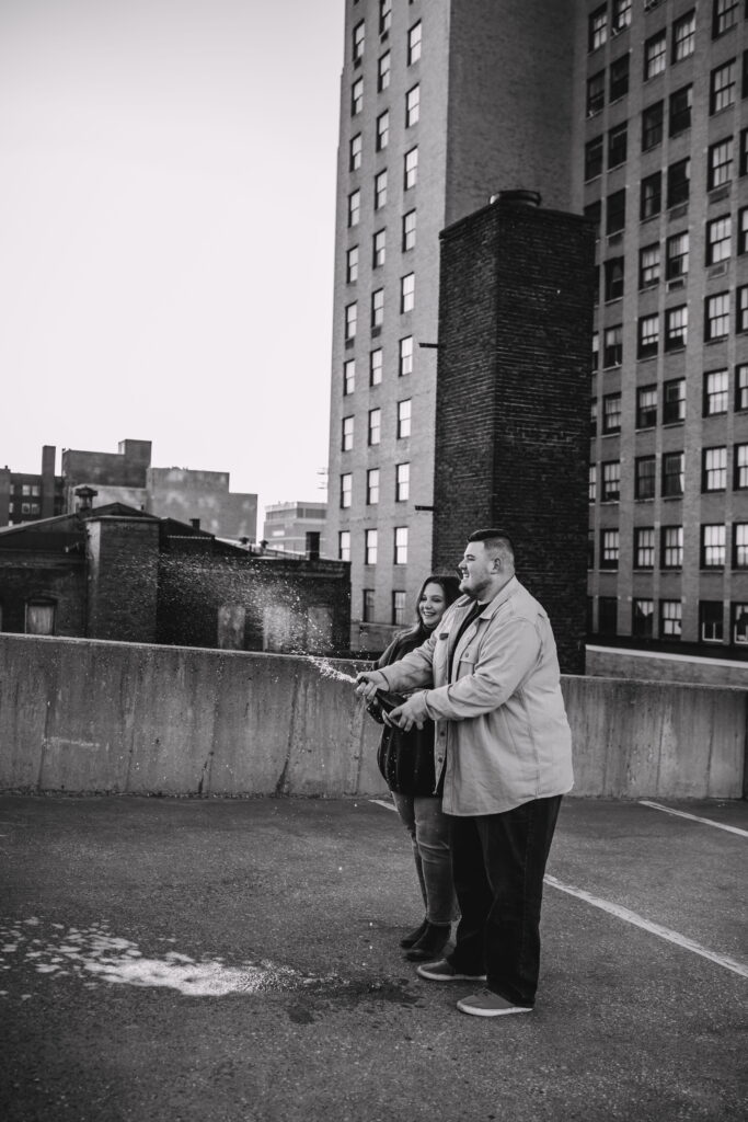 Capturing Love and Emotion: Moody and Romantic Engagement Portraits in Downtown Erie and Pittsburgh, PA by Rylee Louisa Photography. Specializing in Candid Moments on Rooftop Parking Garages, this Wedding and Couples Photographer beautifully portrays the Emotional Essence of Love in Urban Landscapes.