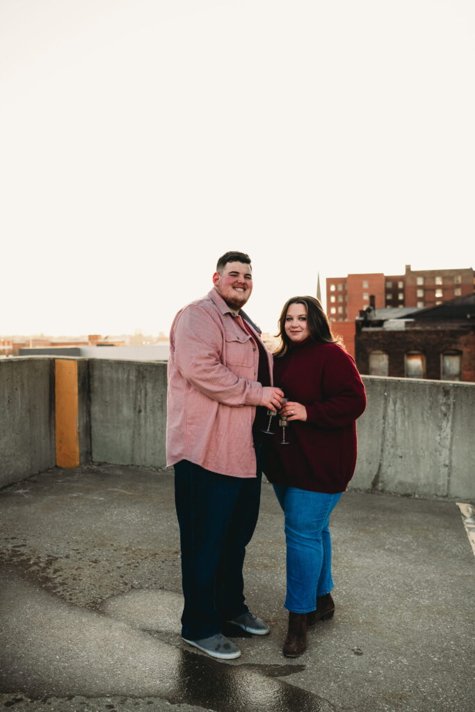 Capturing Love and Emotion: Moody and Romantic Engagement Portraits in Downtown Erie and Pittsburgh, PA by Rylee Louisa Photography. Specializing in Candid Moments on Rooftop Parking Garages, this Wedding and Couples Photographer beautifully portrays the Emotional Essence of Love in Urban Landscapes.