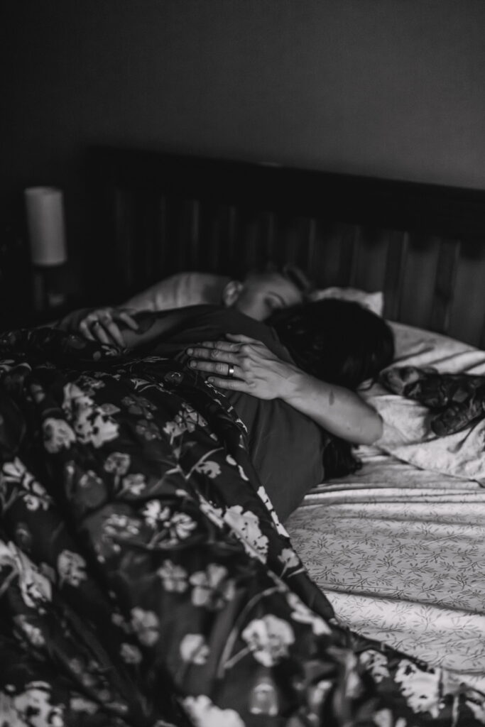 Queer couple getting ready together in bed on their wedding morning, documented by a wedding photo film team in Pittsburgh