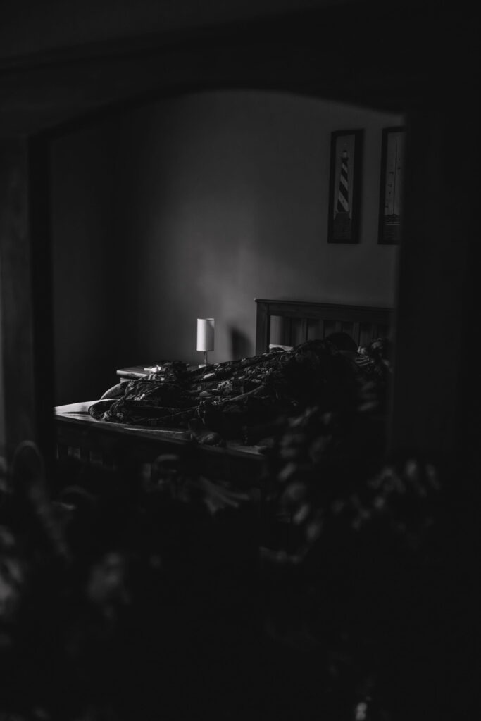 Intimate queer couple sharing a quiet moment together in bed while getting ready for their wedding