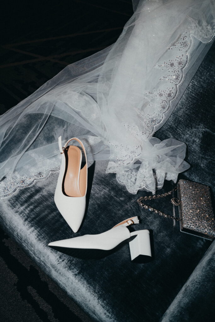 Queer couple photographed at night with direct flash in a bold, documentary wedding style