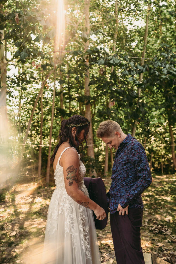 Queer couple getting dressed together on their wedding morning, photographed with a documentary wedding photo film approach