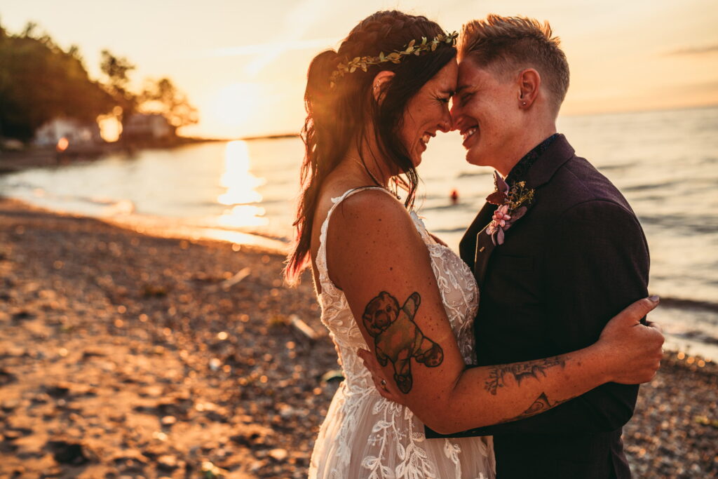 Queer couple reading personal vows together in a private moment away from guests on their wedding day